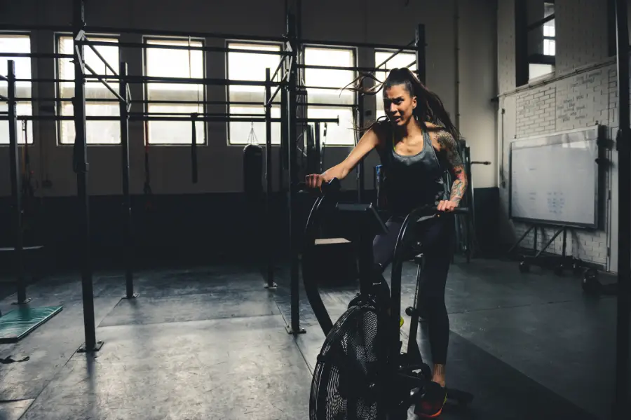 Woman using an air exercise bike