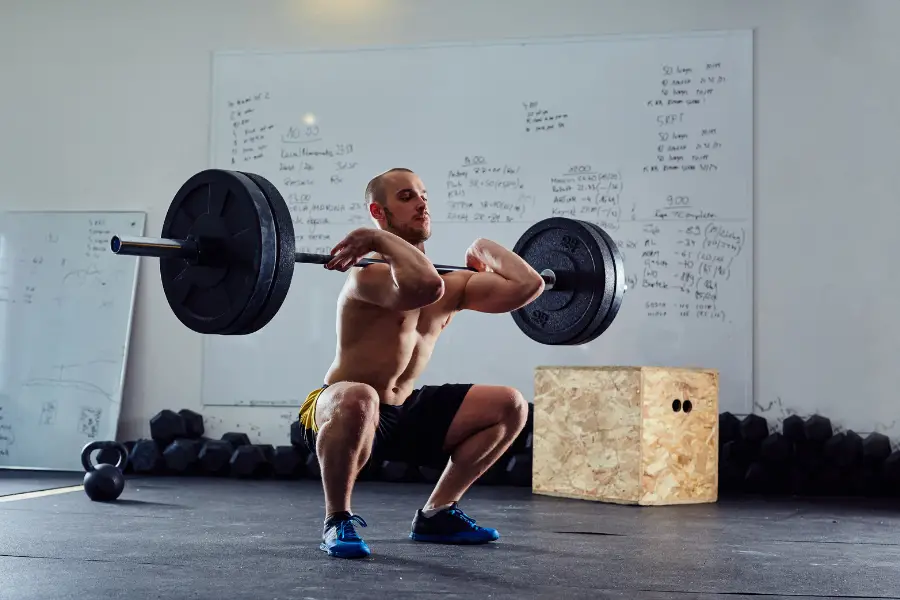 Man using a full size barbell